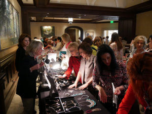 women looking at jewelry at Lifesavers Foundation luncheon and boutique