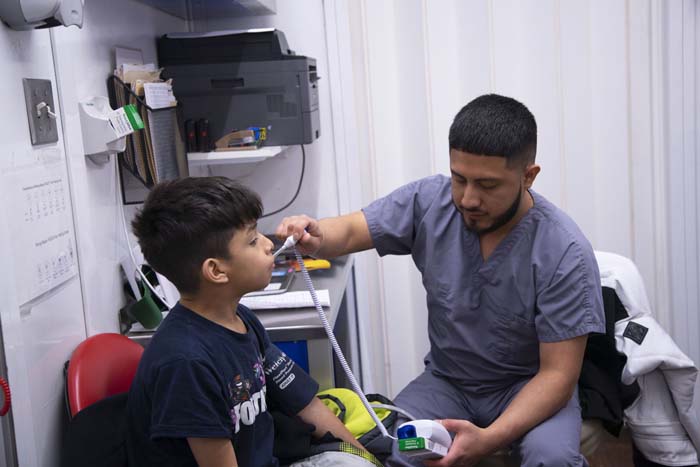 Andres with client inside The Doctor Spot 700x467 medical assistant with patient