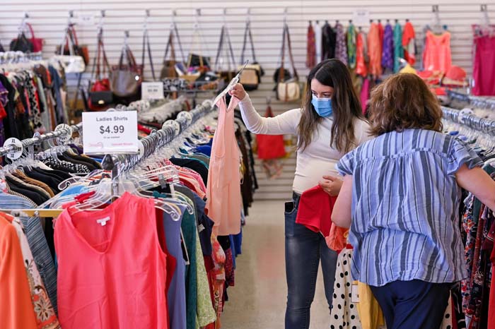 Women shopping at upscale thrift store Women shopping at upscale thrift store