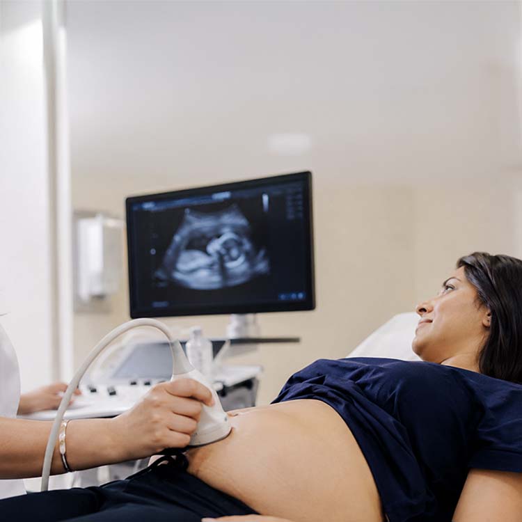 pregnant woman getting a sonogram of baby